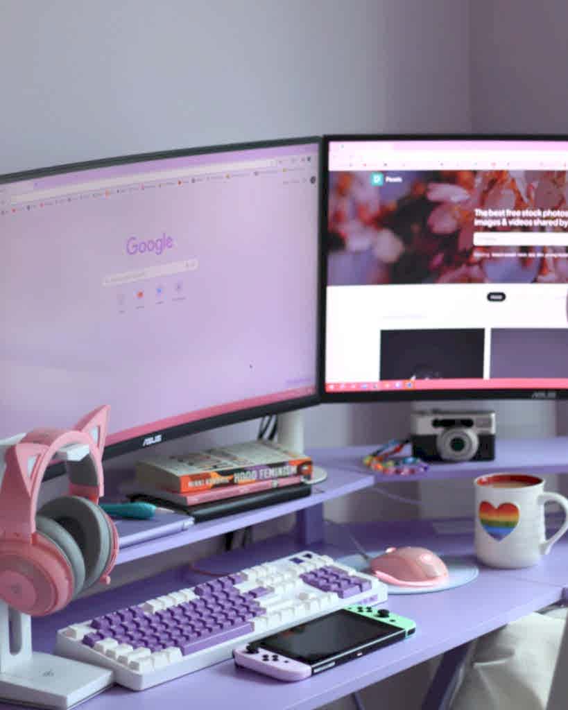 Stylish desk setup with dual monitors, keyboard, headphones, and cozy decor for tech enthusiasts. Ankara Google Ads Reklam Yönetimi Ajansi